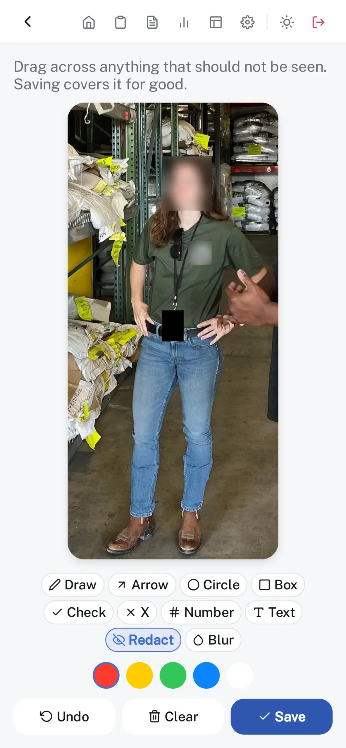 A photo on the Annotate screen with a face and a shirt logo blurred and an ID badge redacted before it is attached